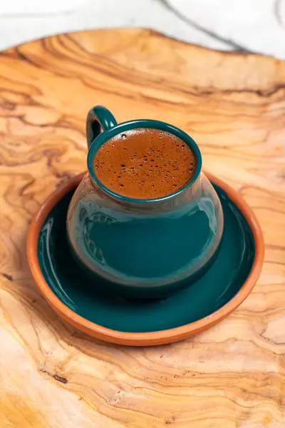 Turkish coffee. Traditional Turkish cuisine flavors. Freshly brewed Turkish coffee on a wooden background. This coffee is very famous in middle east and turkey