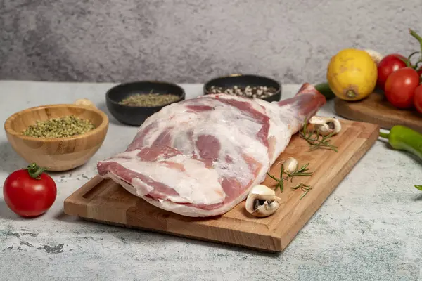 Lamb shoulder meat with bones. Butcher products. Raw lamb shoulder on stone ground