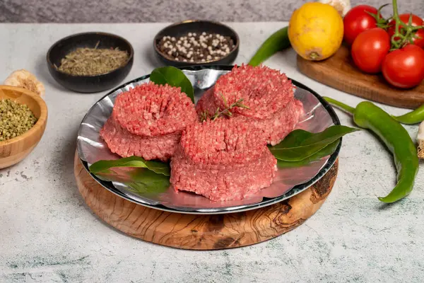 Ground beef. Butcher products. Raw ground beef on stone background