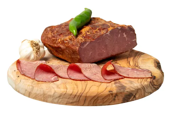 Smoked cold beef sirloin and slices on cutting board. Cold roastbeef slices isolated on white background. Close up