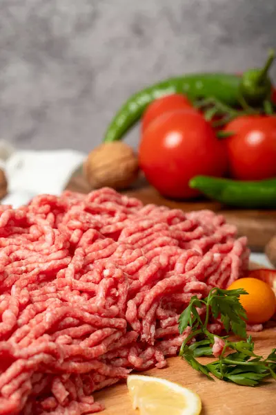 Ground beef. Raw ground beef or minced meat on wood serving board. Close up