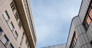 View of modernist buildings against the sky from a human perspective