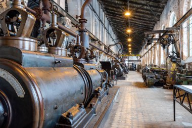 Katowice, Silesia, Poland - January 20th 2023: Hall interior of Walcownia Cynku (zinc rolling mill) with row of four steam engines from 1903. Museum of history of the development of zinc metallurgy.