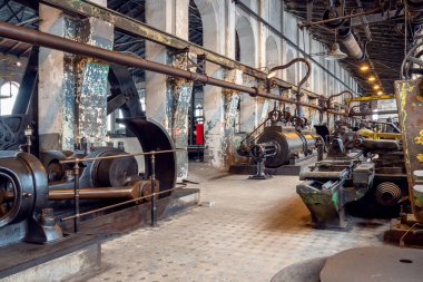 Katowice, Silesia, Poland - January 20th 2023: Hall interior of Walcownia Cynku (zinc rolling mill) with row of four steam engines from 1903. Museum of history of the development of zinc metallurgy.