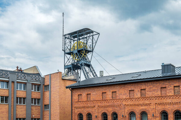 A steel structure of the shaft and a brick post-industrial building. Queen Louise Adit Carnall Zone. Zabrze, Poland