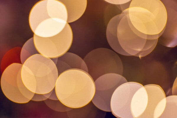 Defocused bokeh lights in blur dark background. Warm colors