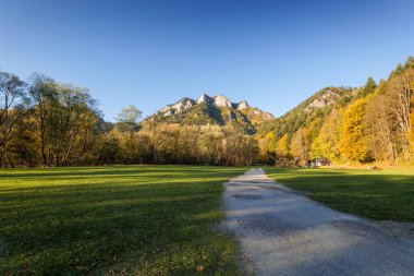 A camping site in the foreground. Beautiful Pieniny mountains. View of the Trzy Korony peak. Autumn in the mountains. Cerveny Klastor, Slovakia clipart