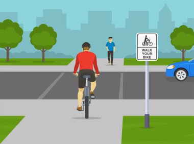 Trafik yönetmeliği kuralları. Bisikletçi bisiklete binerek caddeyi geçmek üzere. Arkadan bak. 