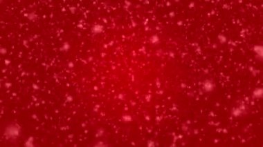 Many white snowflakes falling down on a red background