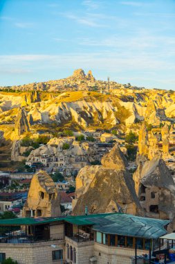Güneş doğarken Cappadocia 'da muhteşem ve seyrek yerleşim yerinin dikey çekimi. Yüksek kalite fotoğraf