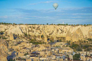 Türkiye 'nin Cappadocia kentinin çarpıcı panoramik görüntüleri, antik mağaralarla muhteşem kaya oluşumları ve şehir üzerinde sıcak hava balonu gezileri düzenlemesiyle tanınıyor. Parlak mavi gökyüzü. Alışılmadık şehir