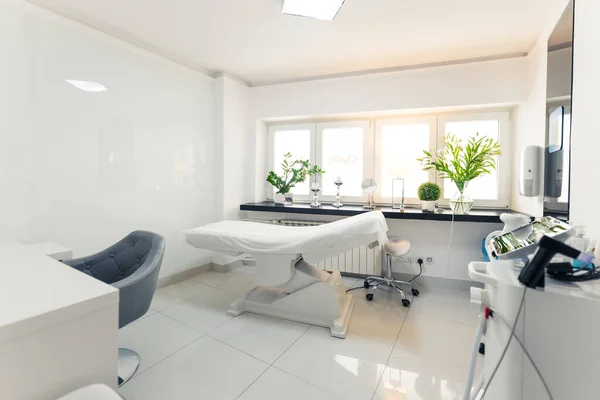Professional beauty salon studio interior. White, clean and hygienic room for aesthetic medicine procedures and various facials. No people. . High quality photo