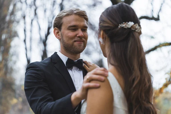 stock image Groom affectionately looking at his bride. Wedding couple standing close in front of each other. High quality photo