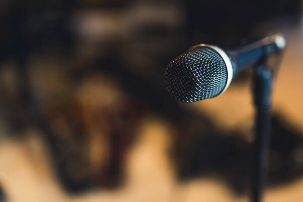 microphone on blurred dark background, music concept recording studio. High quality photo