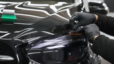 Arabanın farları sönmeye başladı. Profesyonel, gerekli ekipmanları kullanarak hassas hareketleri gerçekleştirir. Yüksek kalite 4k görüntü