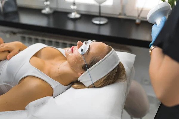 Side-shot of a womans face being prepared for a ThermoLift facial treatment. Beauty concept. High quality photo