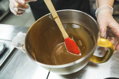 Cooking process of brownies or cupcakes. Liquid batter. Melted chocolate in a bowl with spatula. High quality photo