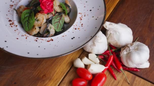 Black Tagliolini Pasta Shrimps Served Deep White Plate Restaurant Interior — Stockvideo