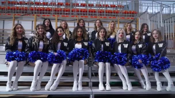 Cheerleaders Mini Skirts Sitting Chairs Posing Camera Holding Pom Poms — Stockvideo