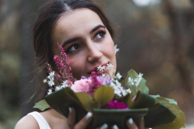 Portrait of an young Turkish Bride in a park by the tree. High quality photo