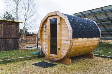 Outdoor sauna with photovoltaic panels in background. High quality photo