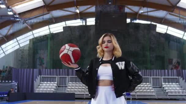 Low Angle Shot Blond Smiling Cheerleader Holding Ball One Hand — Video
