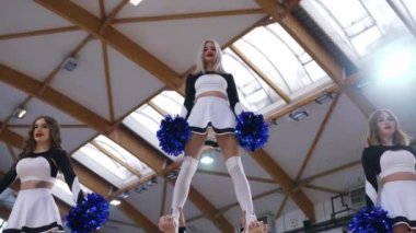 Full shot of a cheerleading squad doing three extension stunts at the same time. Sport concept. High quality 4k footage