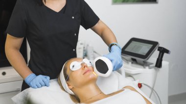 Woman getting an professional laser face treatment. High quality photo