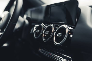 Minimalistic interior of a modern car. Black and gray details in a car cockpit. Inside of a luxury vehicle. Indoor closeup shot. High quality photo