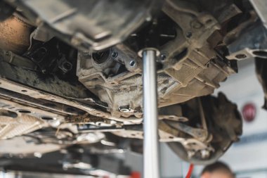 replacing car clutch and gearbox in the auto repair shop, closeup view, repairment process. High quality photo