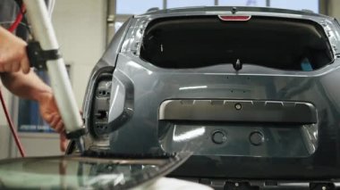 Mechanic adding glue to the windscreen of a car windshield replacement station. High-quality 4k footage