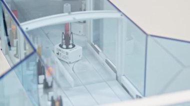 Both full and empty test tubes moving one after another in an automated lab. Lab concept. Close shot. High quality 4k footage