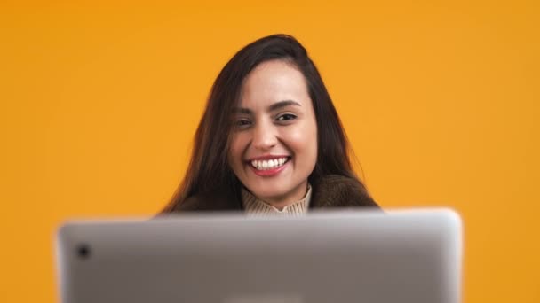 Smiling Brunette Girl Holding Laptop Isolated Orange Background High Quality — 图库视频影像