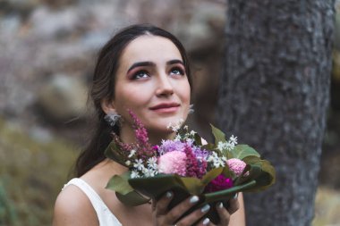 Portrait of an young Turkish Bride in a park by the tree. High quality photo