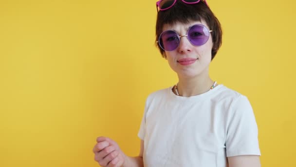 Young Short Haired Woman Wearing Multiple Pairs Sunglasses Looking Camera — 图库视频影像