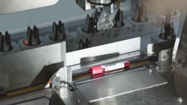 Blood samples being picked and taken up by a machine while being on a production belt. High quality 4k footage