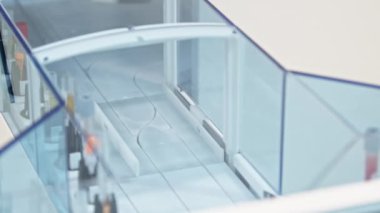 A single full test tube in a holder moving along the line of an automated lab. Medicine concept. Close-up. High quality 4k footage