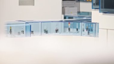 Long shot of many test tubes moving around on an automated lab line. Lab concept. High quality 4k footage