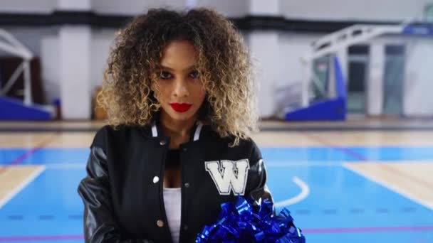 Curly Haired Cheerleader Pom Poms Standing Confidently Arena Posing High — Wideo stockowe
