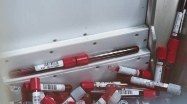 A couple of blood samples being picked by the automatic machine, while other are left in the holder. Blurred foreground. High quality 4k footage