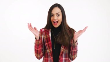 Surprised young woman gesturing with her palms isolated over white background. High quality 4k footage