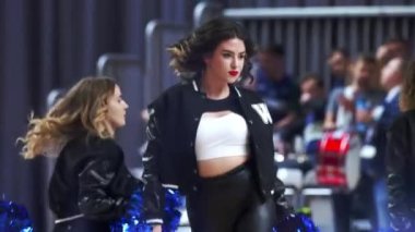 Caucasian cheerleaders performing on court, medium shot indoors. High quality 4k footage