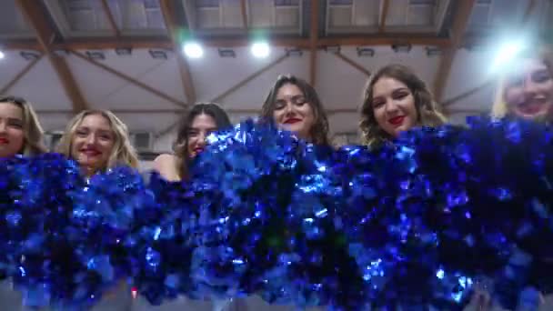 Cheerleaders Standing Row Waving Pom Poms Camera Full View Indoors — Stock video