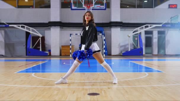 Cheerful Cheerleader Sitting Split Floor Pom Poms Her Hands Arena — Wideo stockowe