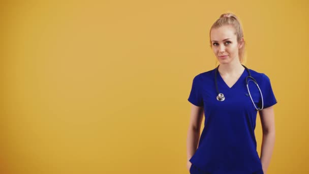 Positive Female Nurse Portrait Posing Stethoscope Yellow Background High Quality — Stockvideo