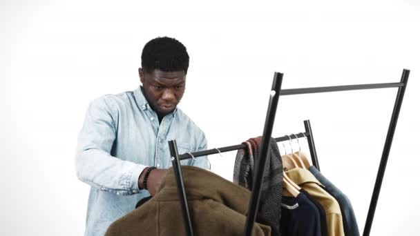 Black American Man Choosing Winter Coat Variety Coats Hanging Rack — Vídeos de Stock