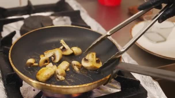 Hands Chef Sauteing Mushrooms Skillet Using Tongs Less Cooking Oil — 图库视频影像