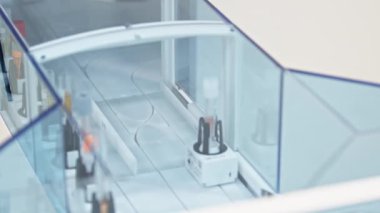Close shot of an empty test tube in a holder moving along the line of an automated lab. Lab cocnept. High quality 4k footage