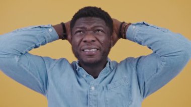 Stressed Afro-American man doing calculations in his head, tensed over losing money. High-quality 4k footage