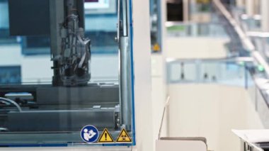 An automated lab machine hand moving behind the glass. Lab concept. Healthcare concept. High quality 4k footage